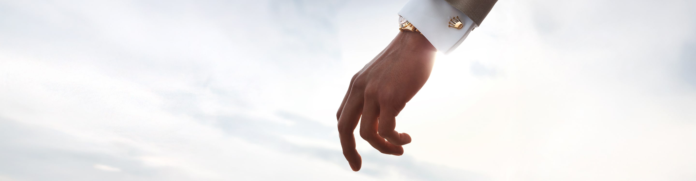 Wrist wearing Rolex cufflink accessory