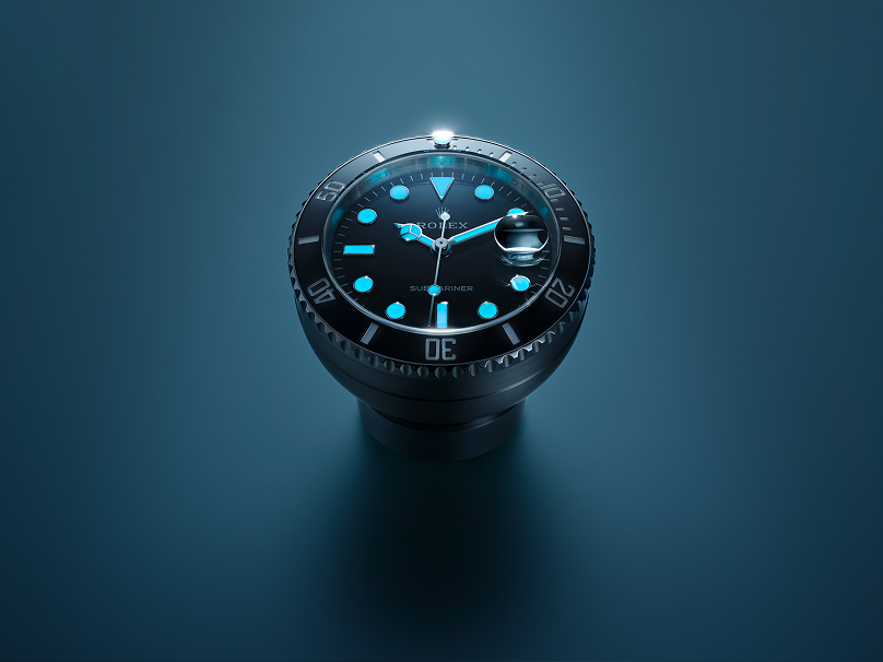 Rolex Desk clock on a desk glowing in the dark