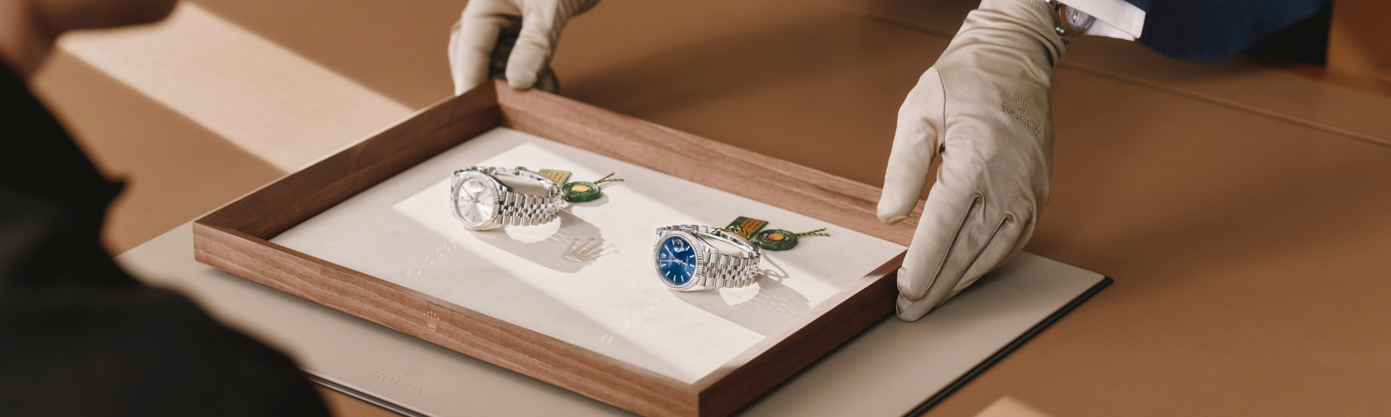 Salesperson showing a Rolex watch to customer