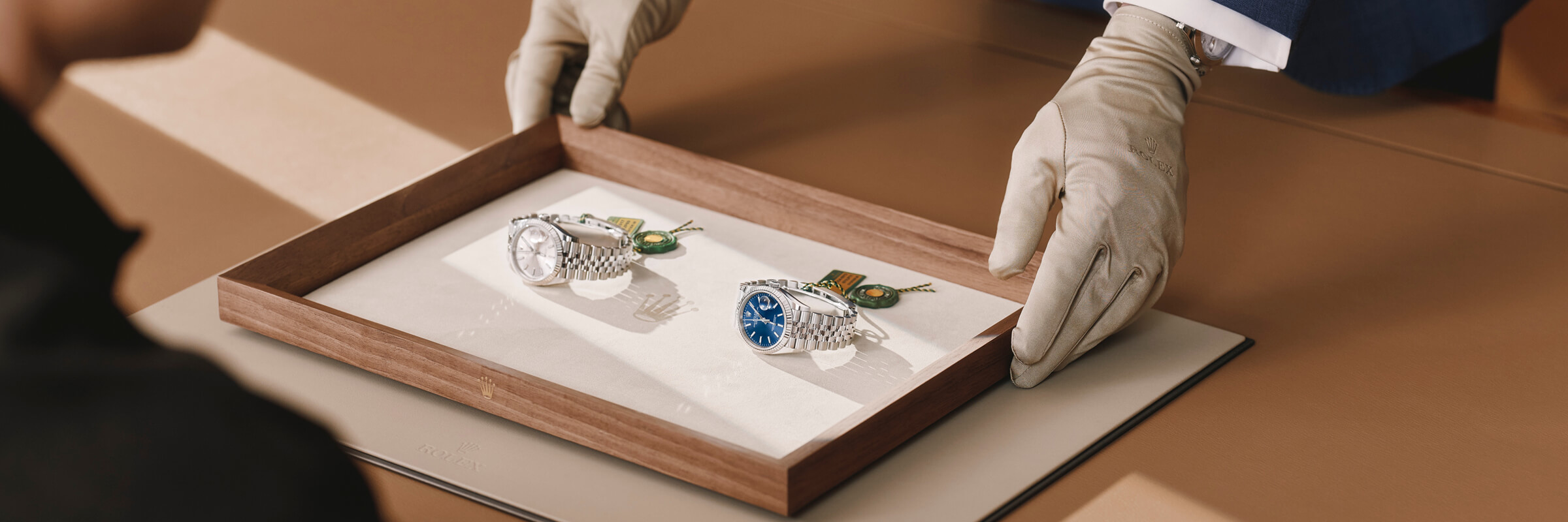 Rolex dealer showing a watch to a customer