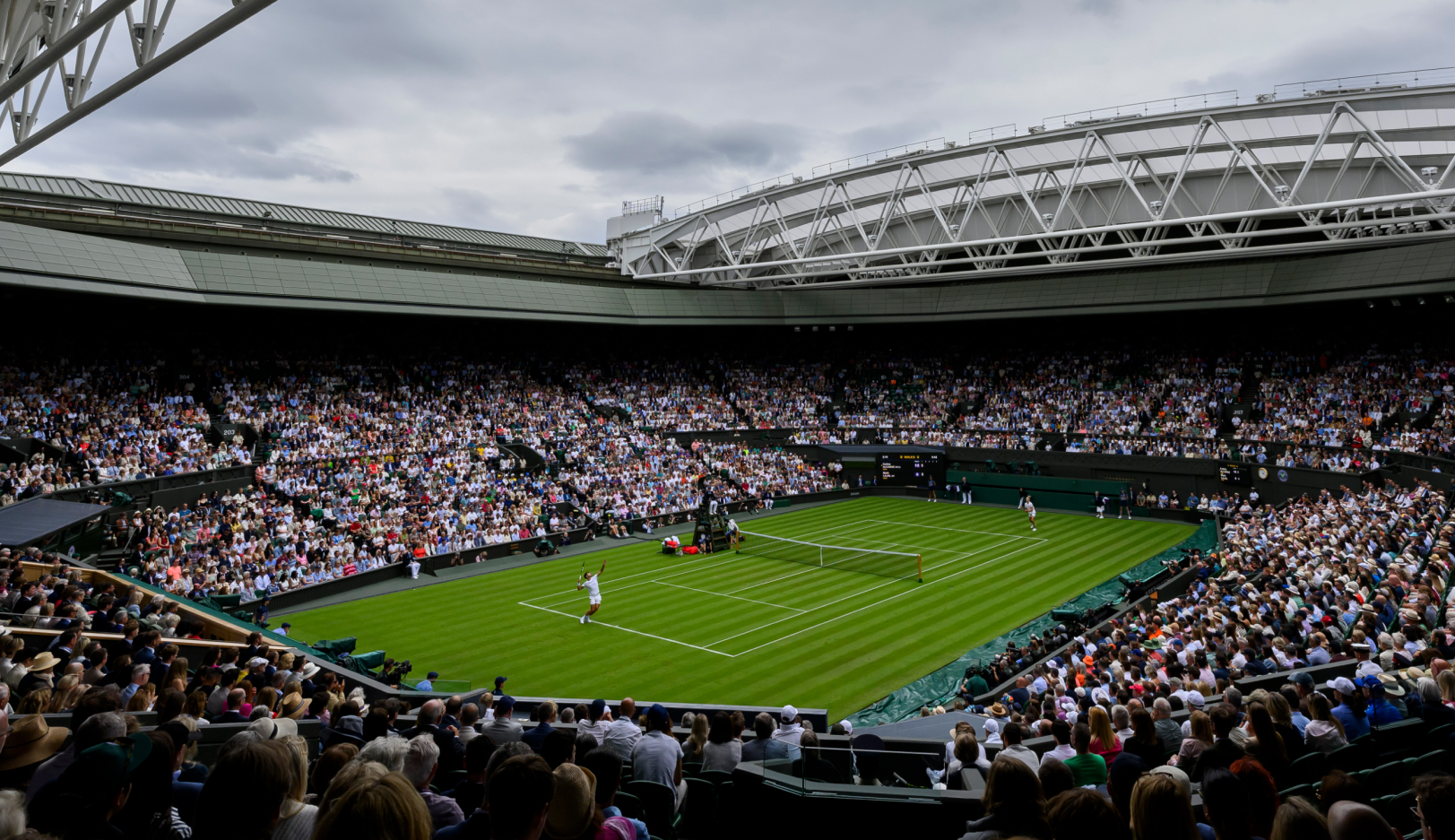Image of man serving a tennis match
